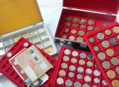 a lot of coins in a red case on a table