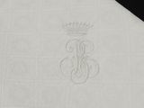 the napkin has a monogram on it and a crown on it