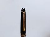 a close up of a fountain pen with a black nib