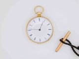 a gold pocket watch and a rope tied to it