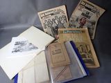 a pile of old newspapers and other papers on a table