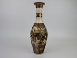 a brown and white vase sitting on a white surface