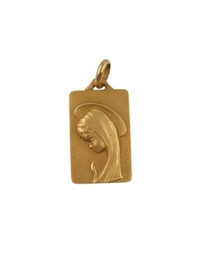 a gold plated pendant with a woman ' s face on it