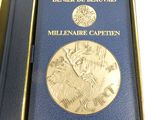 medal in a blue box with a gold medal on it
