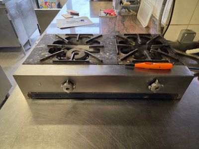 stainless steel counter top in a commercial kitchen with a stove