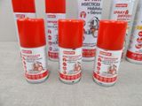 six sprays of red and white spray paint sitting on top of a table
