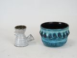 two vases sitting next to each other on a table