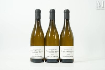 three bottles of white wine sitting next to each other on a table