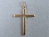a small gold cross on a white background