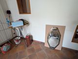 a mirror in the corner of a room next to a fire place