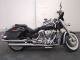 a black motorcycle that is parked in a garage