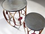pair of metal and glass side tables on a white surface