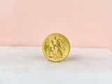 a gold coin sitting on top of a marble slab