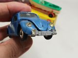 a person holding a small toy car in their hand