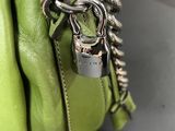 a green purse with a padlock on it