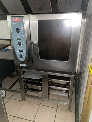 a small commercial oven sitting in a kitchen next to a table