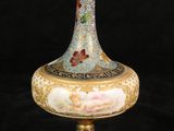 a vase that is sitting on a stand on a black background
