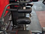 gym equipment in a gym with red walls and black flooring