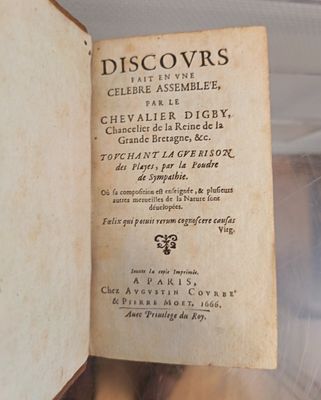 an old book with writing on it sitting on a table