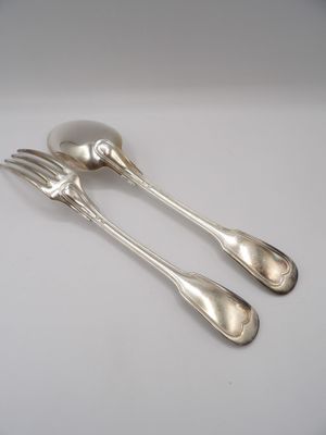 two silver spoons and a fork on a white surface