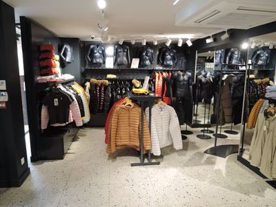 a picture of a clothing store with a lot of clothes