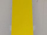 a yellow piece of paper on a white surface