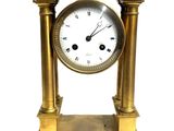 a gold clock that is sitting on top of a table