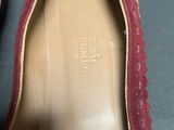 the bottom of a pair of shoes with a red sole