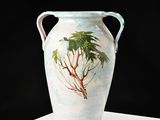 a vase with a painting of a palm tree on it