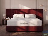 a picture of a bed with a red headboard in a room