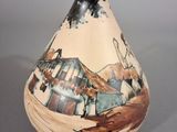 a small vase with a painting on it sitting on a table