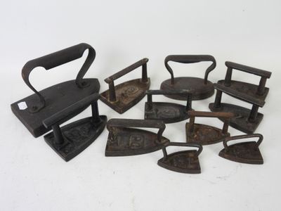 a lot of old irons that are sitting on a table