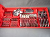 a red tray with silverware and spoons in it
