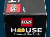 a black box with a lego house on it