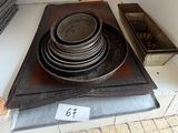 a stack of plates and pans sitting on top of a stove