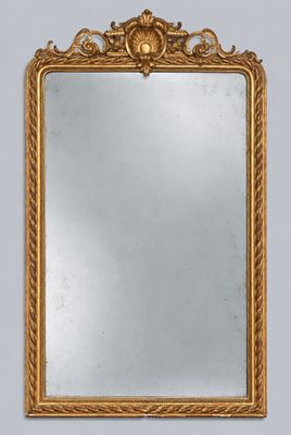 a gold framed mirror on a wall with a white background