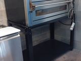 two ovens sitting next to each other in a room