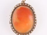 an image of a pendant with an orange stone in the center