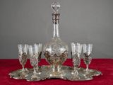 a silver tray with wine glasses and a decanter on it