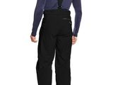 the back view of a man in black pants and a blue shirt