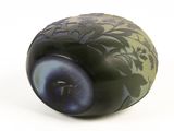 a black vase with a green and blue design on it