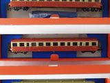 three model trains in a display case on a table