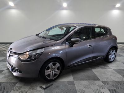 a grey car is parked in a room with a checkered floor