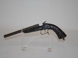 an old gun on a clear stand on a white surface