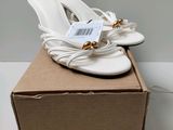 the box has a pair of white shoes on top of it