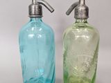 pair of blue and green glass soap dispensers
