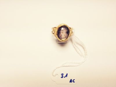 a picture of a ring with a picture of a man on it