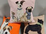 three pillows with dogs on them sitting next to each other