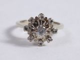 a close up of a diamond ring on a white surface