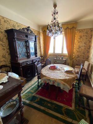a dining room with a table, chairs, and a china cabinet
